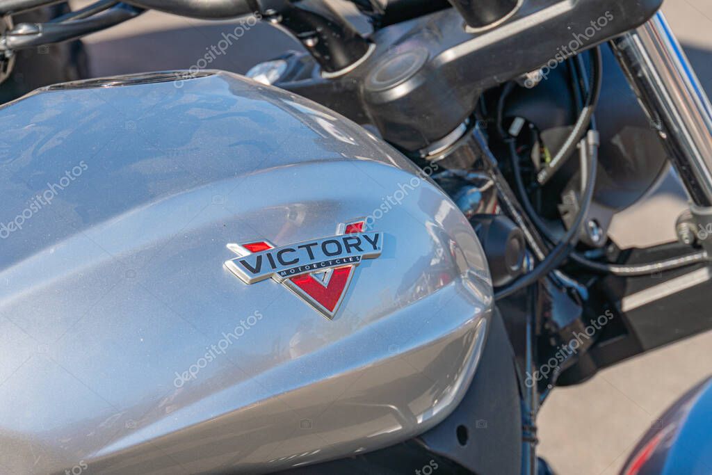 Close-up view of a black and gray Harley Davidson motorcycle with VICTORY on the fuel tank and brand logo featuring an angelic V Taken from an angled perspective, Kyiv, Ukraine - September 21, 2025