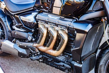 Harley-Davidson motosiklet motoruna yakın plan, dikey yerleştirilmiş krom egzoz borularına odaklı, siyah-metalik renk tonlarına, düşük açılı perspektife, doğal I Kyiv, Ukrayna - 21 Eylül 2025