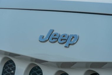 Bir Jeep ambleminin ve ızgaranın bir kısmının doğal gün ışığı altında gümüş ve gri tonlarda çekilmiş yakın plan görüntüsü Jeep An Kyiv, Ukrayna - 21 Eylül 2025