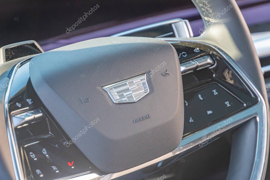 Close-up image of a Chryslers steering wheel, showcasing the General Motors logo and surrounding controls in a modern interior with neutral color palette, soft ligh Kyiv, Ukraine - September 21, 2025