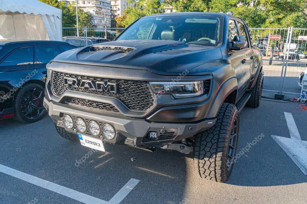 Black, heavily modified Ram truck with aggressive body kit, matte finish, large tires, robust appearance, angle parking, soft lighting, nondescript background, natur Kyiv, Ukraine - September 21, 2025
