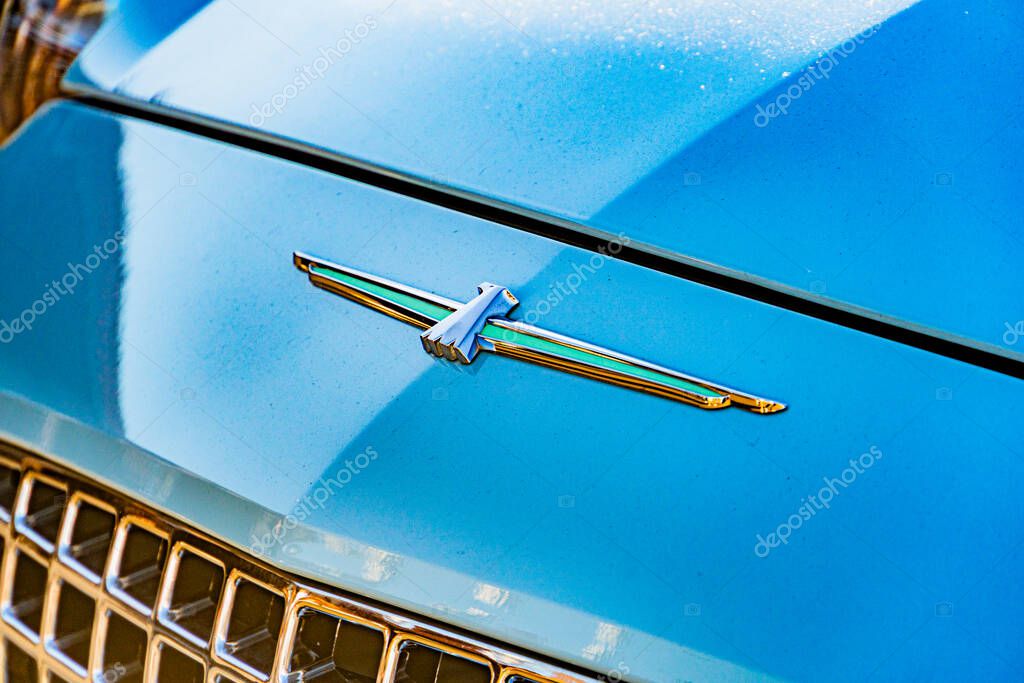 Blue Ford Thunderbird from rear-three quarter angle, emblematic grille with eagle figure, round headlights, chrome bumper, bright lighting, soft shadows Kyiv, Ukraine - September 21, 2025