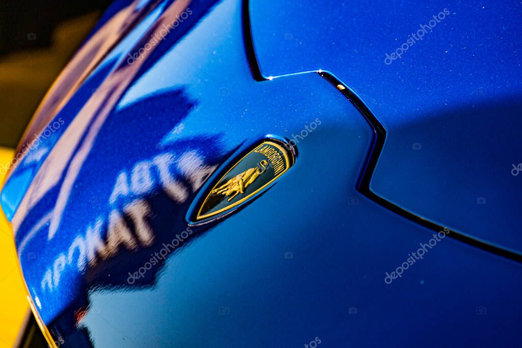 Close-up view of a blue Lamborghini, showcasing its sleek design and vibrant color Perspective above the vehicle, highlighting side profile with logo on door Soft Kyiv, Ukraine - September 21, 2025