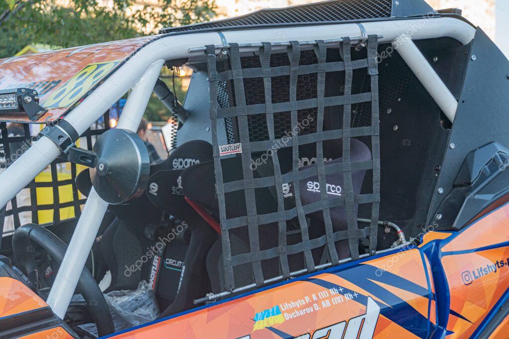 Orange and blue racing car in an evening sky on track, sleek design with unoccupied cockpit sunsetsunrise lighting casting shadows Kyiv, Ukraine - September 21, 2025