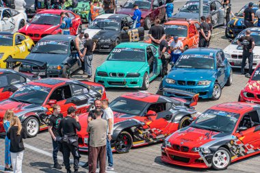 Bir Kyiv Araba Sürükleme Festivali 'nin düşey kompozit görüntüsü, tasarım ve renk, kırmızı, bl Kyiv, Ukrayna 06-15-2025 üzerine odaklanarak çeşitli spor arabalara ve yarış araçlarına odaklanıyor.