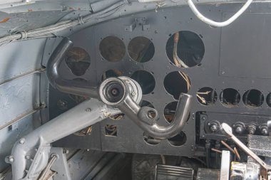 İğne göstergeleriyle çoklu dairesel göstergelerin yer aldığı ve etrafını çevreleyen küçük göstergelerle donatılmış bir uçak enstrüman panelinin yakın çekimi. Metal yapı, endüstriyel arka plan, çevre aydınlatma.