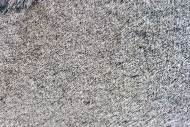 Orta Avrupa 'nın antik bir köyündeki kumu andıran karmaşık, tanecikli bir desene yakın çekim. Sönük renkler, kahverengi, gri, siyah ve yumuşak gölgelerle dokulara derinlik katar.