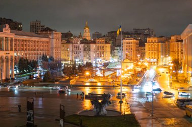Kiev Meydanı Meydanı 'nın gece manzarası, aydınlatılmış klasik binaların bulunduğu şehir merkezi, trafik ve yayaların yoğun olduğu caddeler, ıslak kaldırım Kyiv, Ukrayna - 12 Kasım 2025