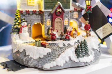 Ukrayna 'nın başkenti Kyiv' de 12 Kasım 2025 'te bir kır evi, ağaç ve figürlerle süslenmiş minyatür bir Noel köyü.