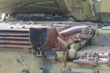 İşaretsiz bir Ukrayna tank motor kompartımanının yakın görüntüsü, çoğunlukla kahverengi ve gri, sağ üst köşeden çekilmiş, teknik tarzda, hatta ışıklandırmalı.
