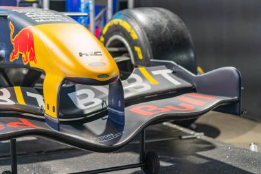 Yellow and black Formula 1 car on display in industrial garage or exhibition area Car branded with Red Bull Racing, TAG Heuer, Pirelli and Aston Martin Cur Kyiv, Ukraine - June 7, 2025