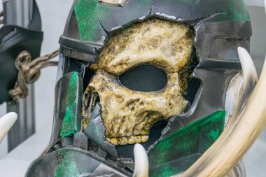 Yeşil ve siyah, sıkıntılı Star Wars kostüm başlığı heykeli paslanmış metal elementlerle insan kafatasını andırıyor, görünür çatlaklar ve çatlaklar, açılı perspektif, Kyiv, Ukrayna - 7 Haziran 2025