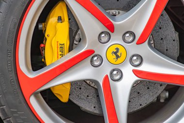 Ferrari amblemli çok dilli gümüş ve kırmızı jantların yer aldığı bir spor araba tekerleği ve süspansiyon sisteminin yakın plan görüntüsü yüksek performanslı Kyiv, Ukrayna 10-12-2024