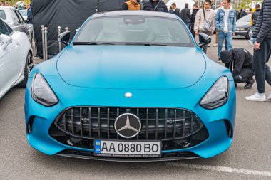 Yüksek kalitede, kendine özgü stil ve büyük alaşım tekerleri olan mavi lüks bir spor araba. Görüntü bir otomobil fuarında ya da Ukrayna 'nın Kyiv şehrinde 10-12-2024