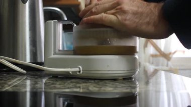 Sabahları portakal suyu yapan bir adam.