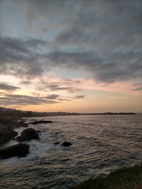 A Marina, Galiçya, İspanya 'da bulutlarla denizin üzerinde gün batımı