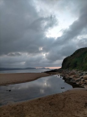 A Marina, Galiçya, İspanya 'da bulutlarla denizin üzerinde gün batımı