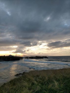 A Marina, Galiçya, İspanya 'da bulutlarla denizin üzerinde gün batımı
