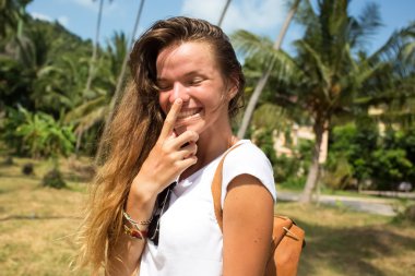 Fashion hipster cool girl in sunglasses and colorful clothes having fun, wearing cute trendy outfit,smiling enjoy her weekends,girl brown hair with an elegant hairstyle,hair wave curly