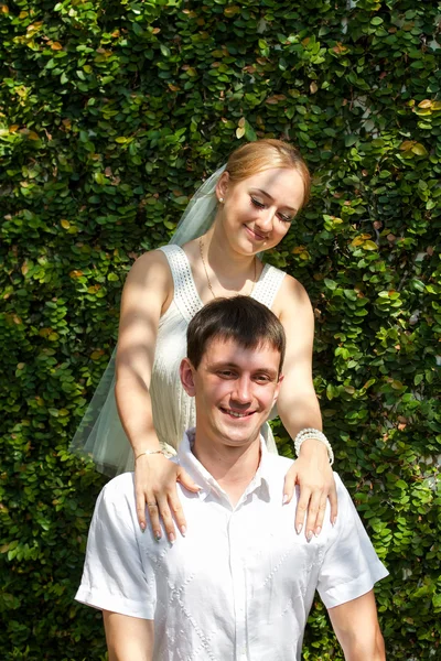 Loving young couple, in white clothes and a white veil, a wedding, summer vacation, love, the relations Royalty Free Stock Photos