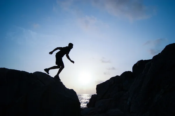 The jumping man on rocks