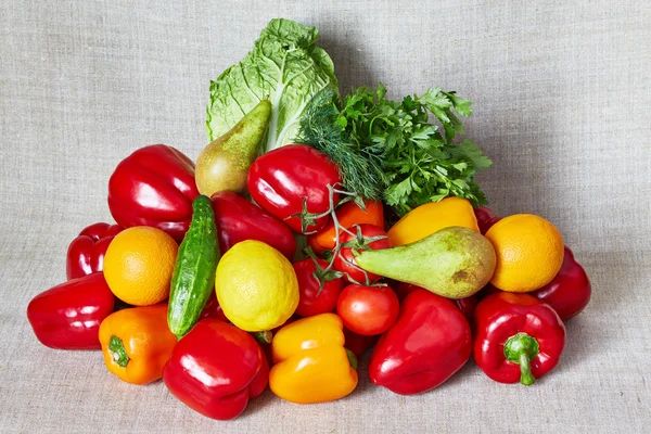 Zöldség és gyümölcs fekszik egy szürke vászon — Stock Fotó