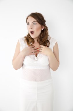 Şaşırmış ve ağzı açık bir şekilde kafasını tutan güzel bir kızın yakın plan portresi. Beyaz arkaplan.