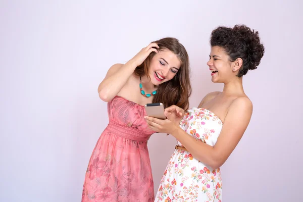 A két lány a különböző birtoklás móka-val smrtfonom. Internet, kommunikáció, barátság — Stock Fotó