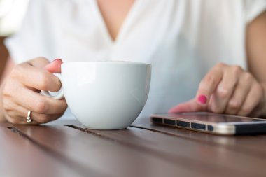 bliska ręce kobiety za pomocą jej telefon komórkowy w restauracji