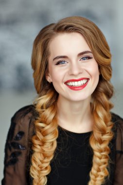 Portrait of a glamorous beautiful girl with bright makeup in bla