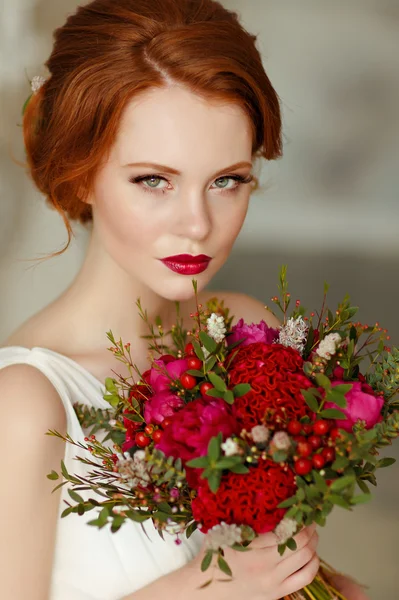 Très jolie fille aux cheveux roux sophistiquée avec un bouquet à la main — Photo