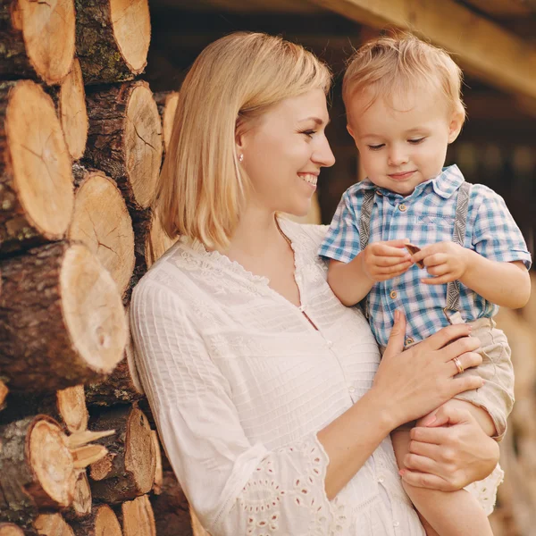 Mom blonde in a white dress holding hands on the little boy, lau — Stock Photo, Image