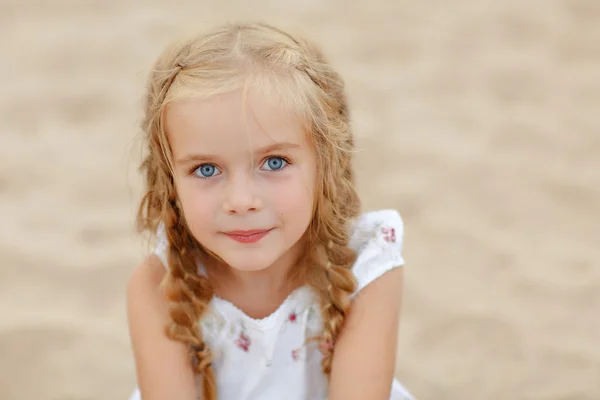 Portrait risible blonde girl with pigtails and blue round eyes — Stock Photo, Image