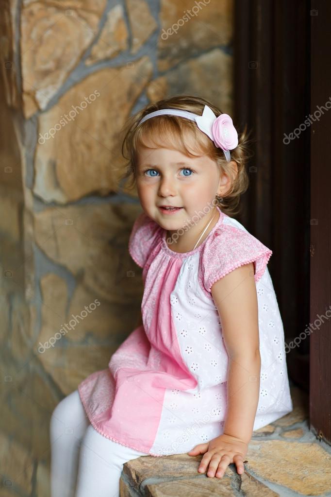 Portrait Of A Pretty Little Girl Baby Blonde With Big Blue Eyes