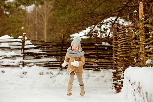 Very nice beautiful girl child in a beige coat and a gray hat ru — Stock Photo, Image