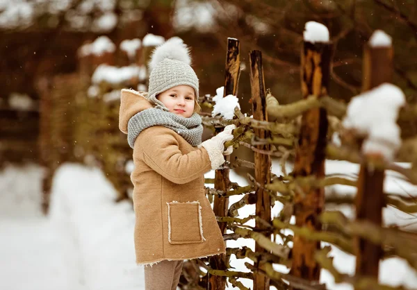 Very nice beautiful girl child in a beige coat and a gray hat is — Stock Photo, Image