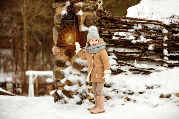 Very sweet beautiful little girl child in a beige coat looks awa — Stock Photo, Image