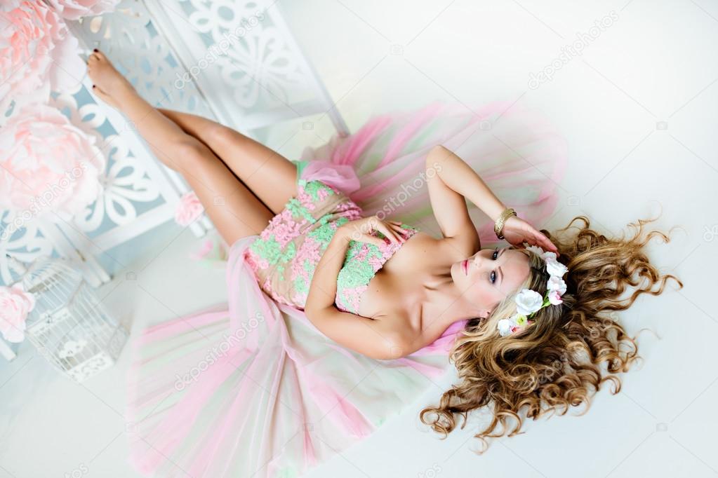 Very beautiful sensual girl with curly blond hair and a wreath o