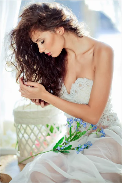 portrait of sensual curly haired girl in a white dress with clos