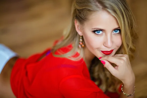 Very beautiful sexy blonde girl with blue eyes in red blouse — Stockfoto