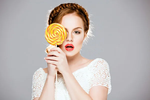 Beautiful red-haired girl holding a Lollipop — Stock Photo, Image