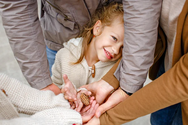 Adorable little curly blonde in beige knitted sweater smiles sly — Φωτογραφία Αρχείου