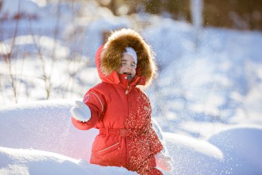 Kar kürk başlık Kırmızı elbiseli küçük şirin kız atıyor 