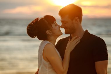 A man and a woman in a lush short skirt, looking at each other t