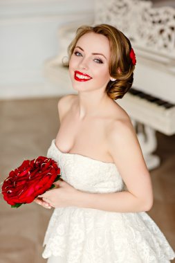 Charming blonde girl with beautiful smile in a white lace dress 