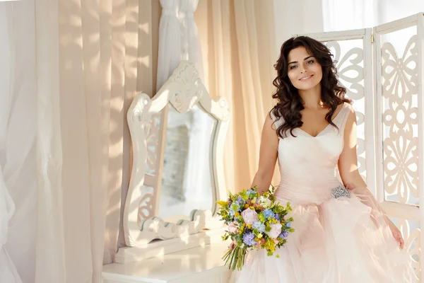 Portrait of a beautiful brunette girl in a pink dress with an ai