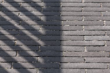 Arka plan - koyu tuğla yapılmış bir kaldırımda gölge.