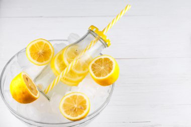 Limonata içmek trendy şişe buzda saman ile.