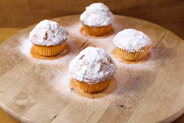 Homemade cupcakes on a wooden cutting board. — Stock Photo, Image