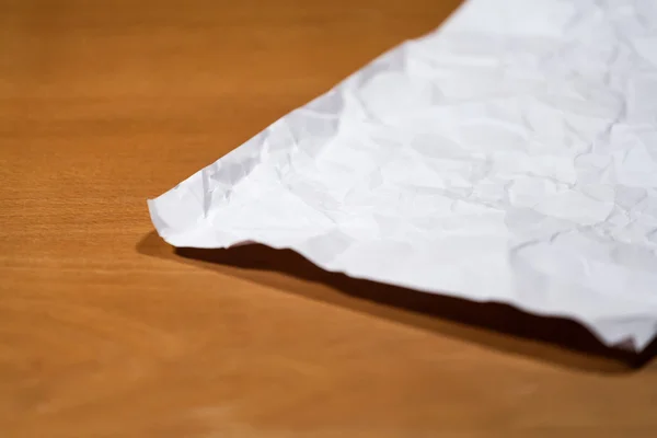 Crumpled paper on a wooden table. — Stock Photo, Image
